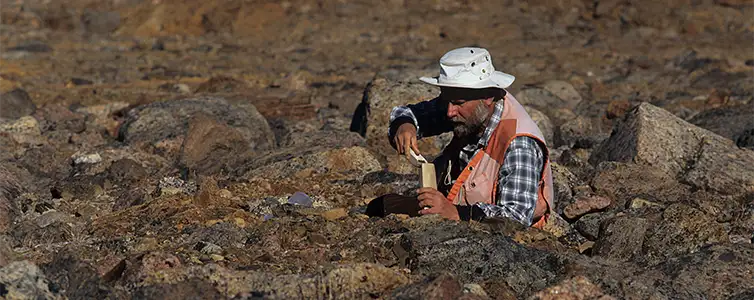 Picture of man taking stone samples